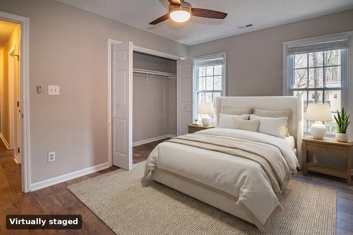 The same bedroom virtually staged with a queen bed, nightstands and rug